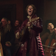 Joey Batey's Jaskier the Bard belts out a song in a crowded tavern in a scene from The Witcher season 2.